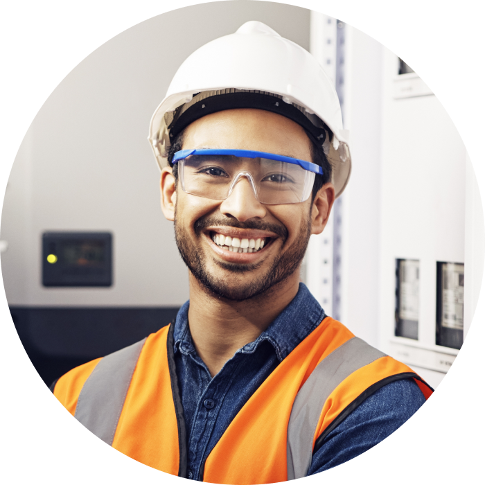 A technician smiling in their work uniform